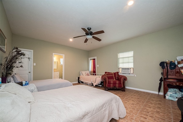 bedroom with ceiling fan, brick floor, cooling unit, connected bathroom, and baseboards