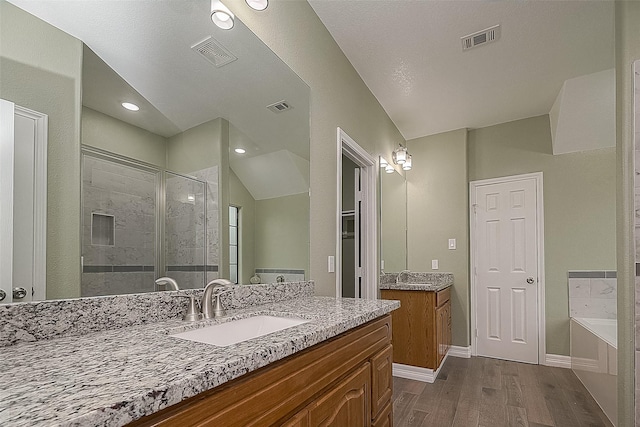 bathroom featuring a stall shower, visible vents, and a sink