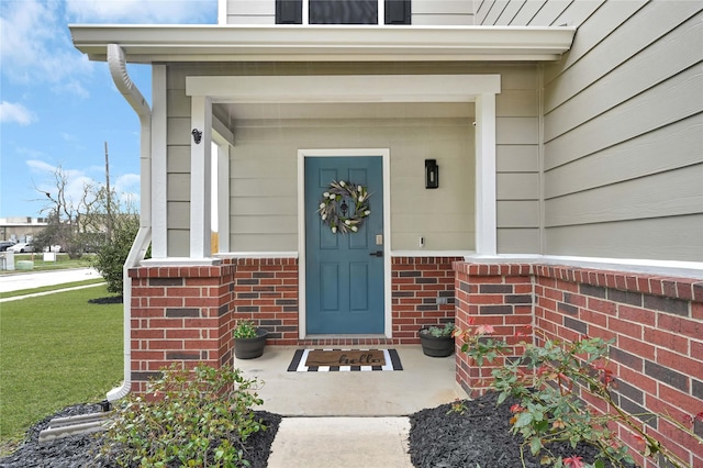 doorway to property with brick siding