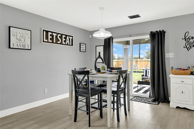 dining room with visible vents, baseboards, and wood finished floors