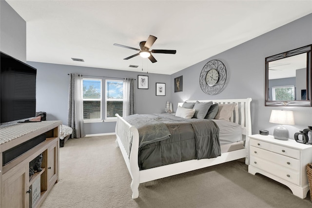 bedroom featuring dark colored carpet, visible vents, and multiple windows