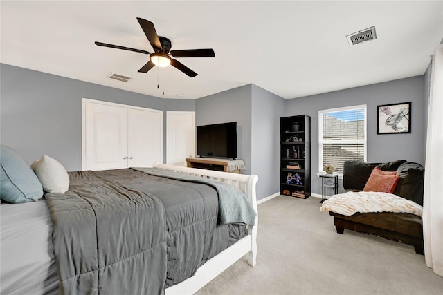 bedroom featuring light carpet, ceiling fan, visible vents, and baseboards