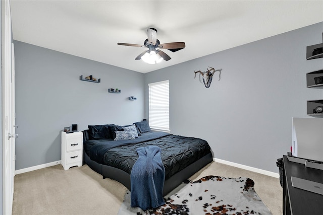 bedroom featuring light carpet, ceiling fan, and baseboards