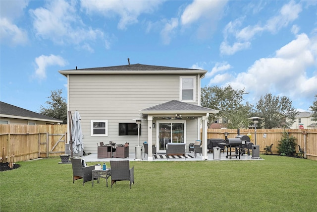 rear view of property featuring a patio area, a fenced backyard, and a lawn