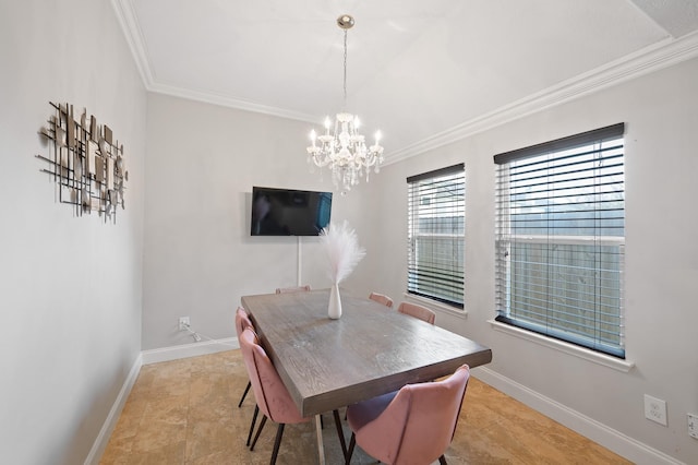 dining area with an inviting chandelier, baseboards, and crown molding