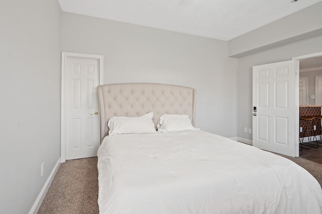 bedroom featuring baseboards and dark colored carpet