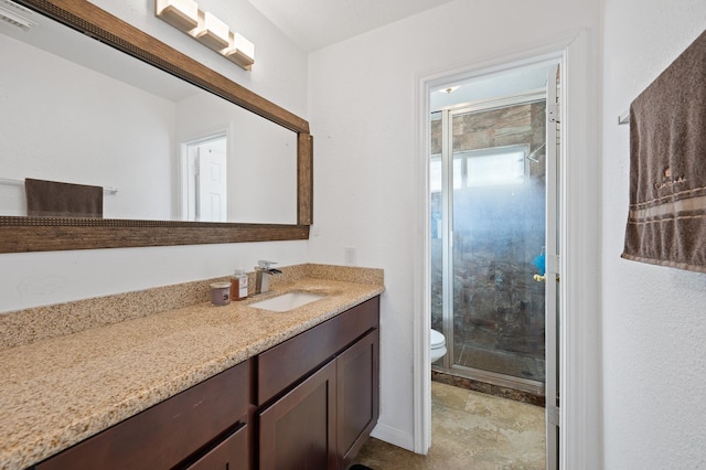 full bath with toilet, a shower stall, visible vents, and vanity