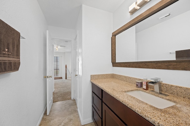 bathroom with visible vents, vanity, and baseboards