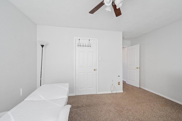 bedroom with carpet floors, ceiling fan, and baseboards