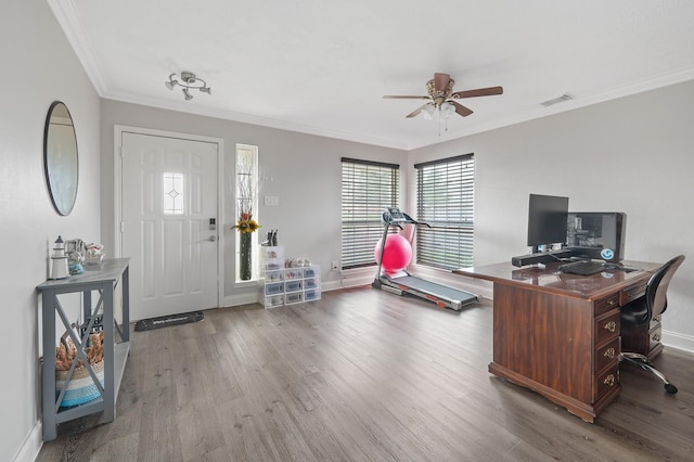 home office with baseboards, wood finished floors, visible vents, and crown molding