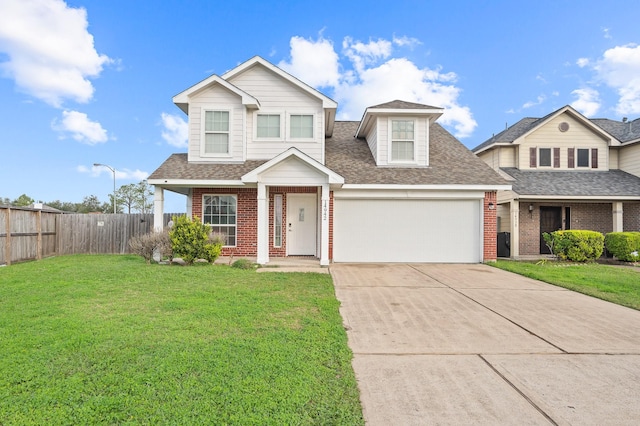 view of front facade with an attached garage, fence, a front lawn, and brick siding