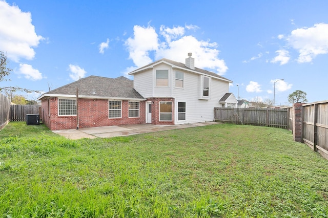 back of house featuring brick siding, a yard, a patio area, cooling unit, and a fenced backyard