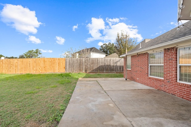 view of yard with a fenced backyard and a patio