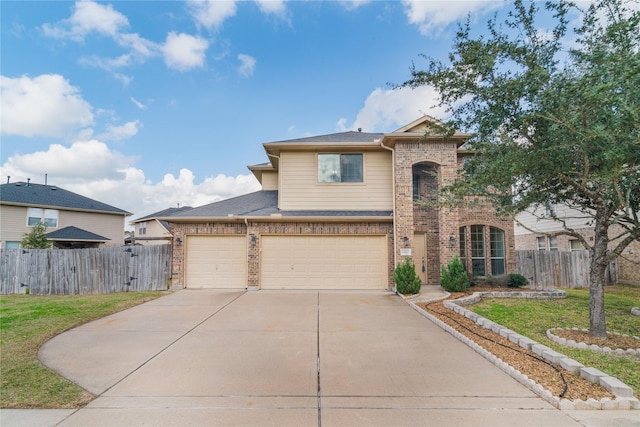 traditional-style home with driveway, fence, a front lawn, and brick siding