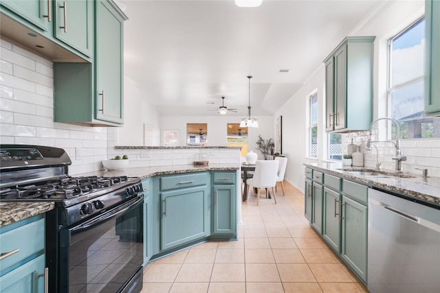 kitchen with light tile patterned floors, a sink, hanging light fixtures, dishwasher, and gas stove