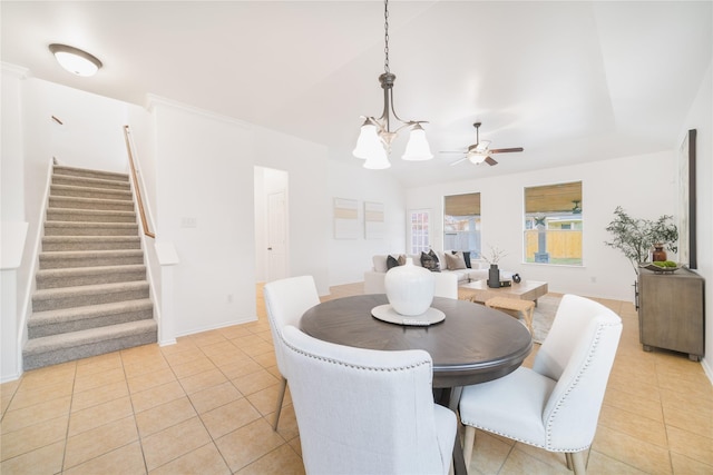 dining space with ceiling fan with notable chandelier, stairs, baseboards, and light tile patterned flooring