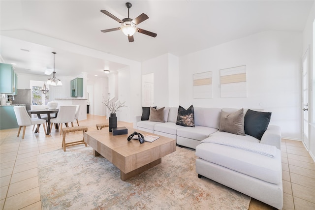 living room with light tile patterned floors and ceiling fan with notable chandelier