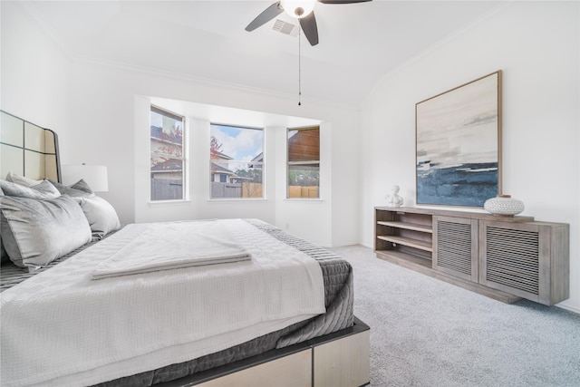 bedroom with crown molding, visible vents, ceiling fan, and carpet flooring