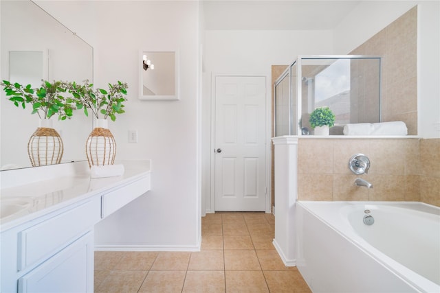 bathroom with tile patterned floors, vanity, a shower stall, baseboards, and a bath