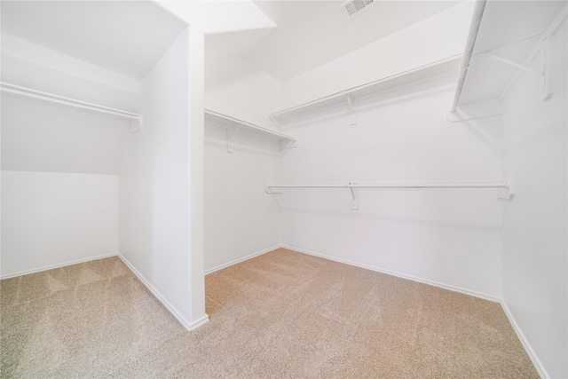 spacious closet featuring light carpet and visible vents