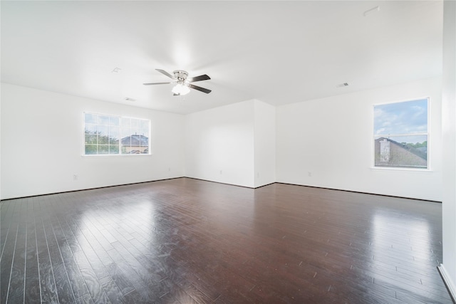 empty room featuring ceiling fan and dark wood-style flooring