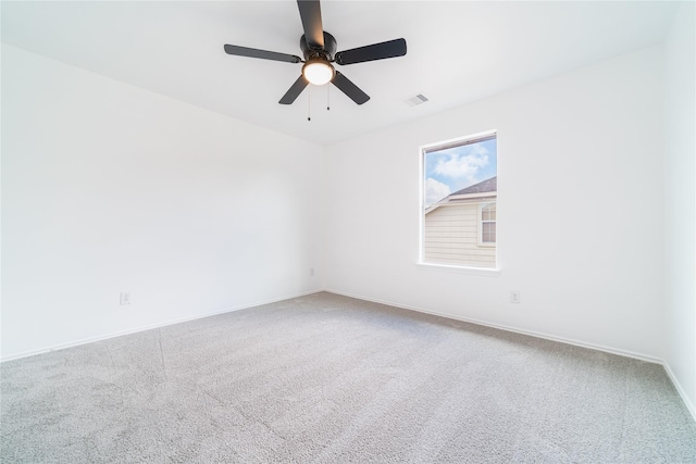 unfurnished room with ceiling fan, carpet floors, visible vents, and baseboards