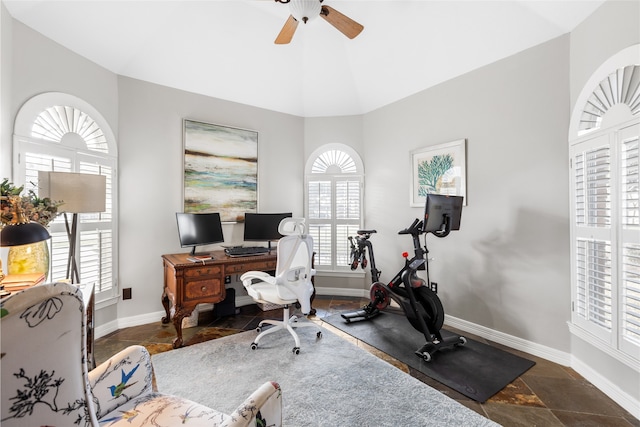 office space featuring baseboards, vaulted ceiling, and a ceiling fan