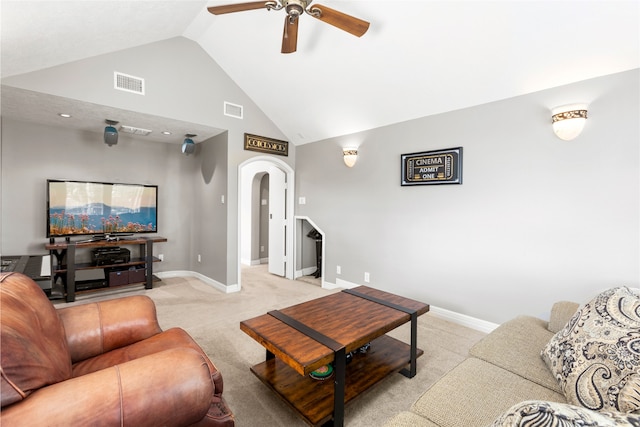 living area with light carpet, ceiling fan, visible vents, and arched walkways