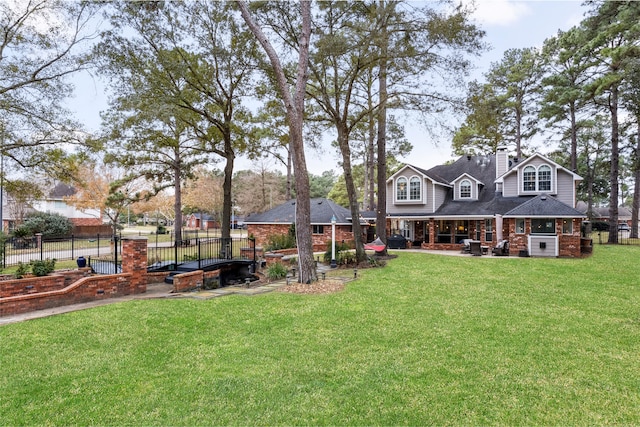 exterior space featuring fence, a chimney, and a front lawn