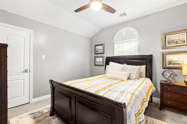 bedroom with visible vents, light carpet, vaulted ceiling, ceiling fan, and baseboards