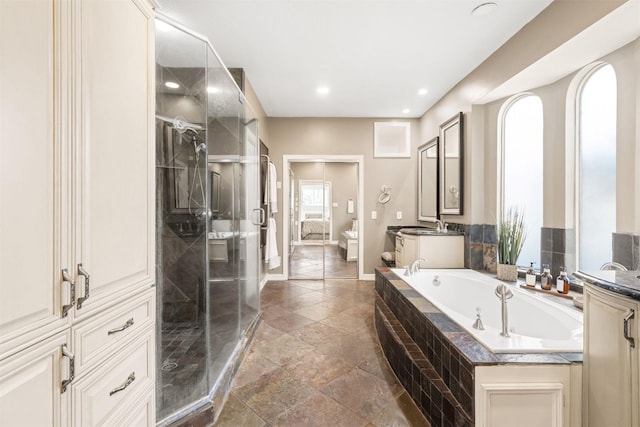 full bathroom with recessed lighting, vanity, baseboards, a shower stall, and a bath