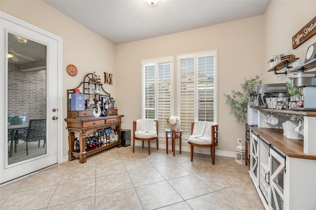 living area with light tile patterned flooring and baseboards