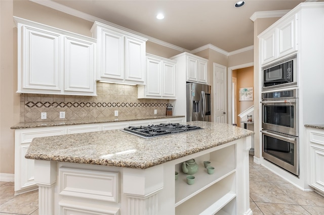 kitchen featuring stainless steel appliances, light stone countertops, a kitchen island, and open shelves