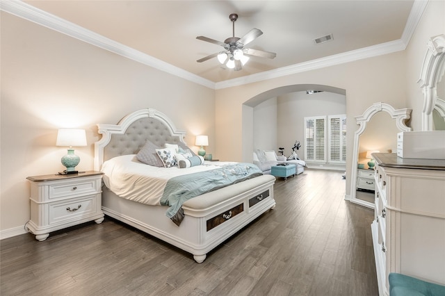 bedroom featuring dark wood-type flooring, visible vents, crown molding, and baseboards