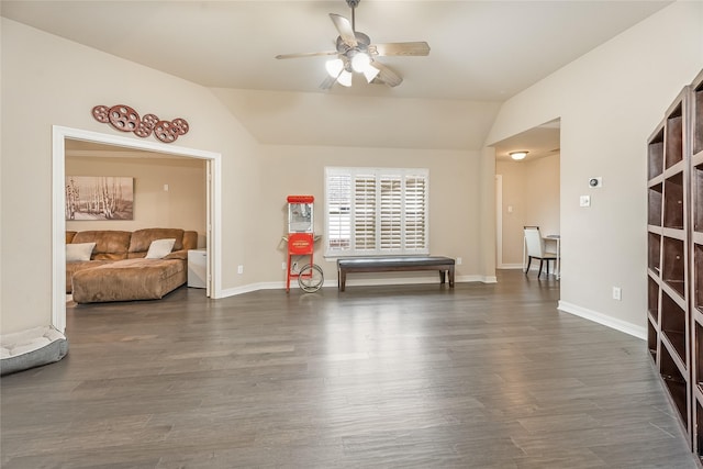 interior space with lofted ceiling, dark wood-style floors, baseboards, and a ceiling fan