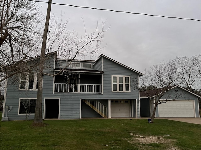 back of property with a garage, a yard, and stairway