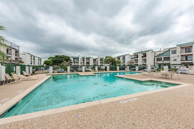 pool featuring a patio area and fence