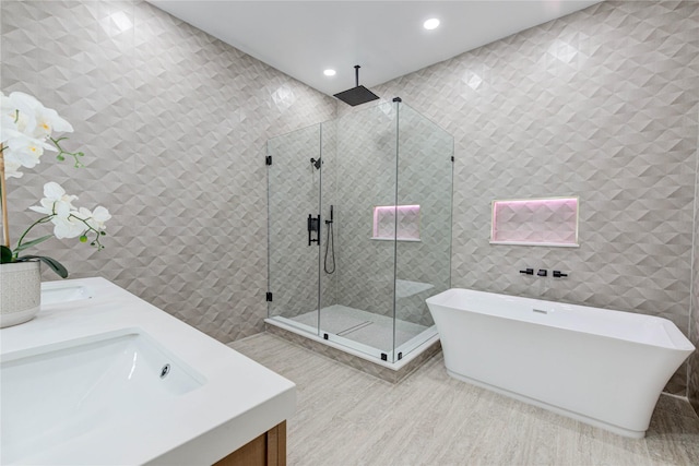 7517 Olympia Dr, Houston, TX 77063 - full bath featuring tile walls, double vanity, recessed lighting, a soaking tub, and a stall shower