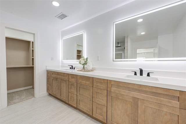 full bath with double vanity, visible vents, a sink, and recessed lighting