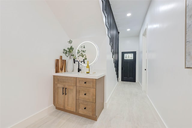 hallway with recessed lighting and baseboards