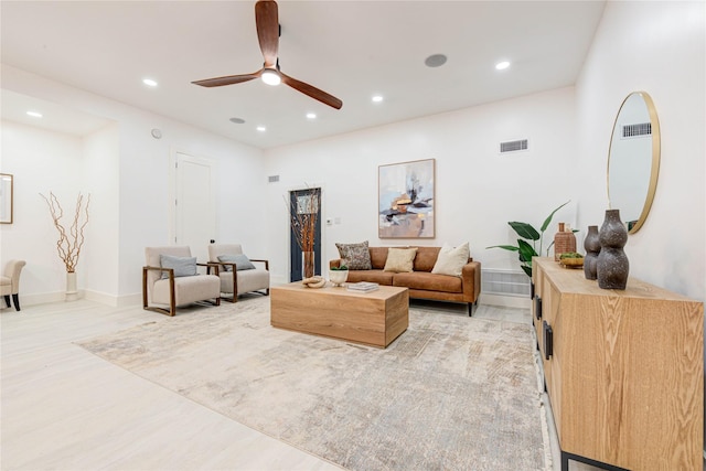 living room with light wood-style flooring, visible vents, a ceiling fan, and recessed lighting