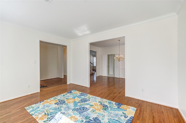 bedroom with a chandelier, baseboards, wood finished floors, and ornamental molding