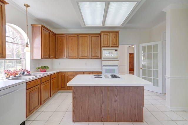 kitchen with a sink, white appliances, light tile patterned floors, and light countertops