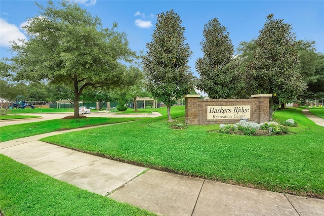 view of property's community with a lawn