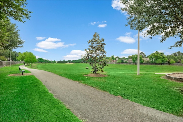 surrounding community with a lawn and fence