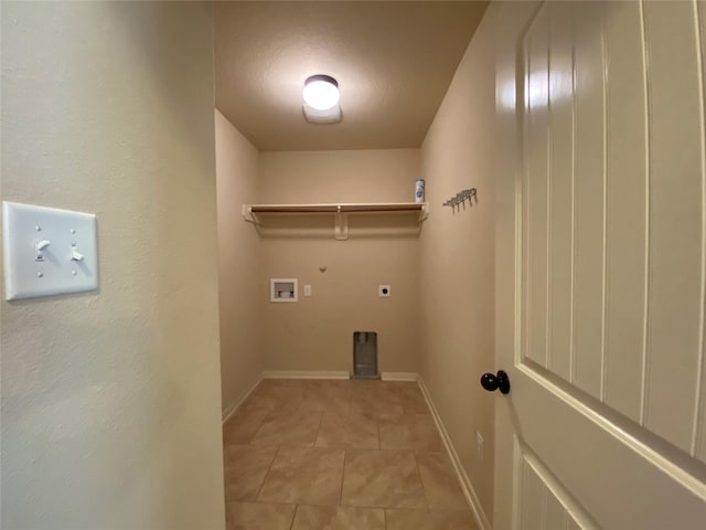 laundry room featuring laundry area, light tile patterned floors, baseboards, gas dryer hookup, and hookup for an electric dryer