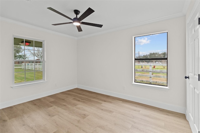 unfurnished room featuring ornamental molding, light wood-style flooring, and baseboards