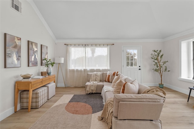 living area featuring baseboards, visible vents, ornamental molding, vaulted ceiling, and light wood-type flooring