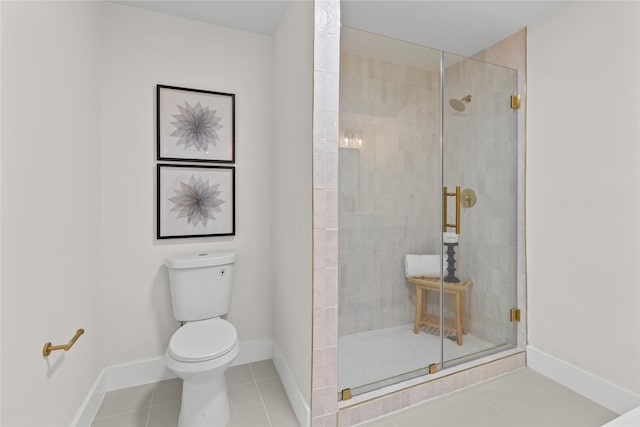 full bath featuring toilet, a stall shower, tile patterned flooring, and baseboards