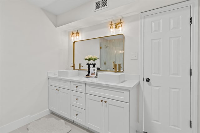 bathroom featuring visible vents, a sink, a shower stall, and double vanity